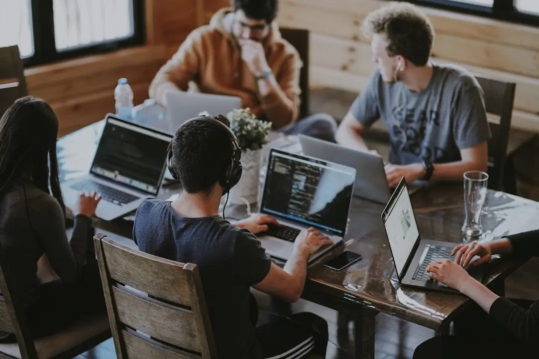 Diverse group of professionals in a modern office looking at a presentation